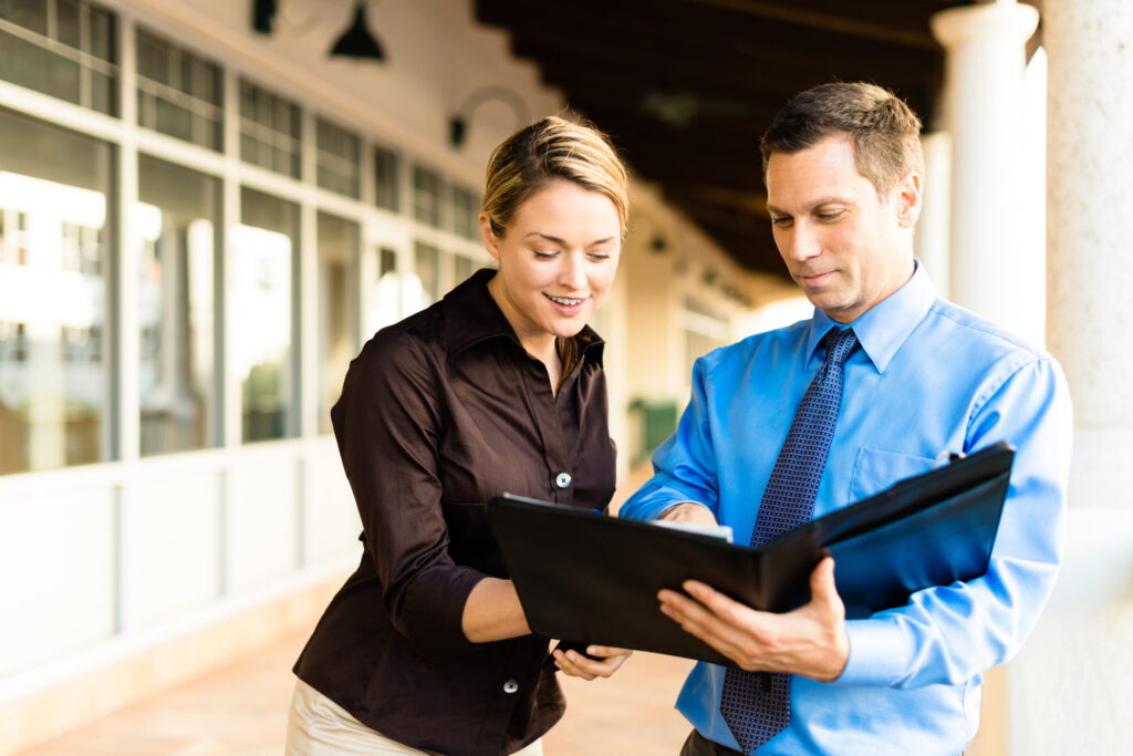 Businessman and businesswoman outside offices